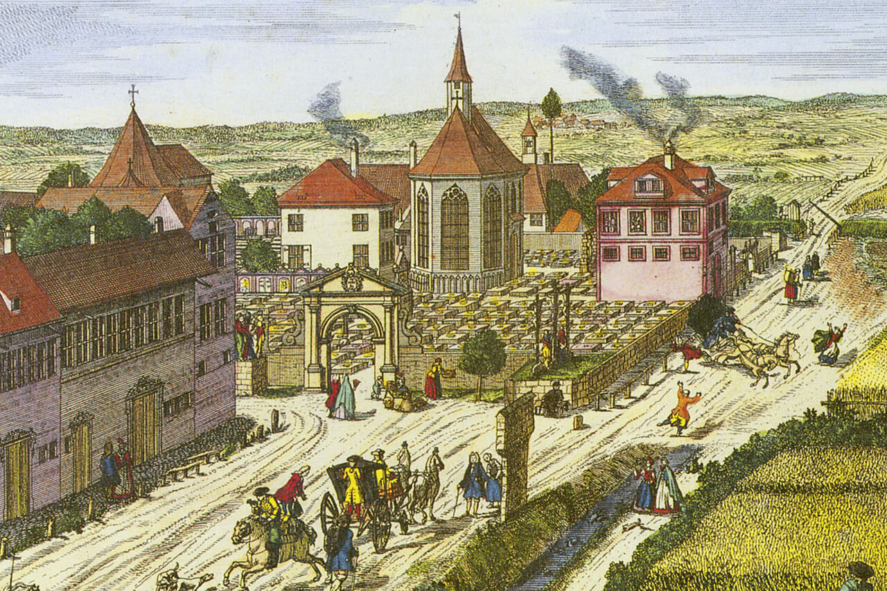 Kolorierter Stich vom Johannesfriedhof mit Gräbern, Kapelle und umgebenden Wohnhäusern, davor eine breite Straße, im Hintergrund grüne Felder